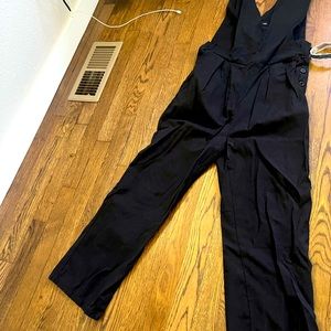 Black cloth romper. In good condition. Only worn once. One size fits all.